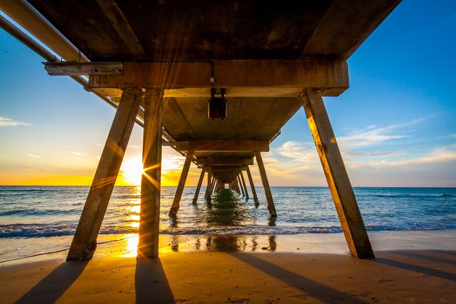 Sunset over the sea beneath the Glenelg jetty
