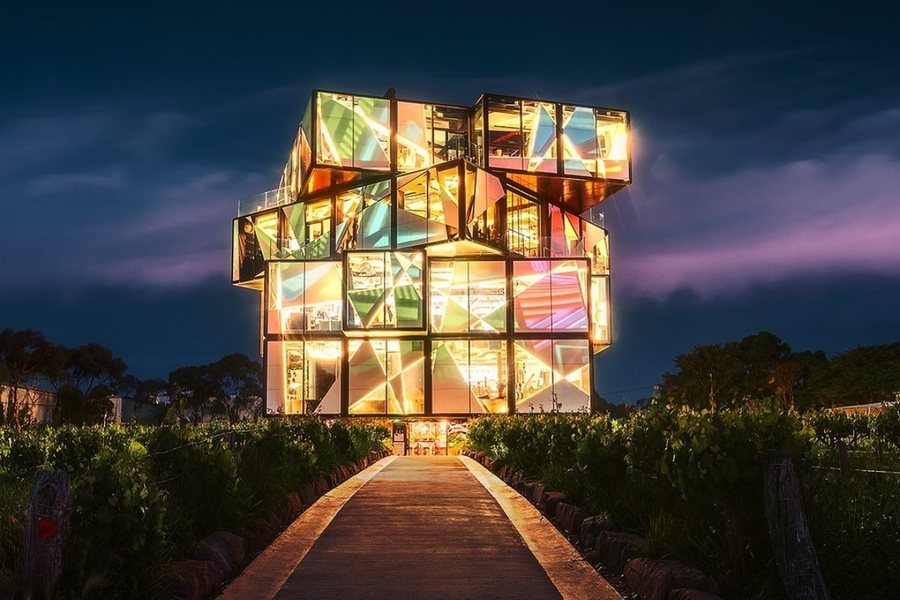 The d'Arenberg Cube glowing at dusk at the end of a vineyard path in McLaren Vale
