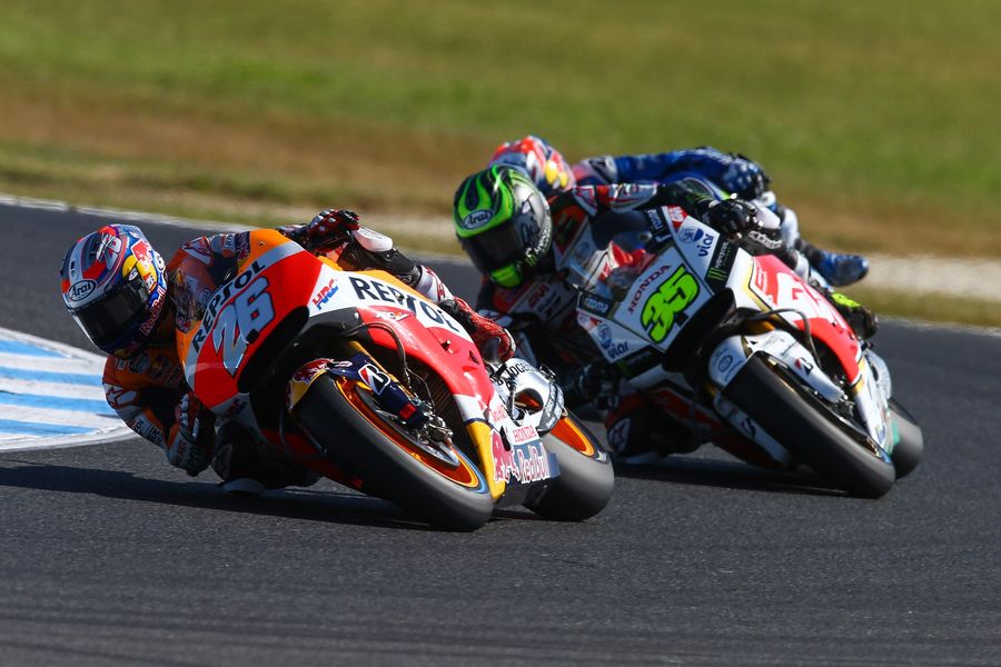 Two MotoGP riders leaned into a corner mid-race